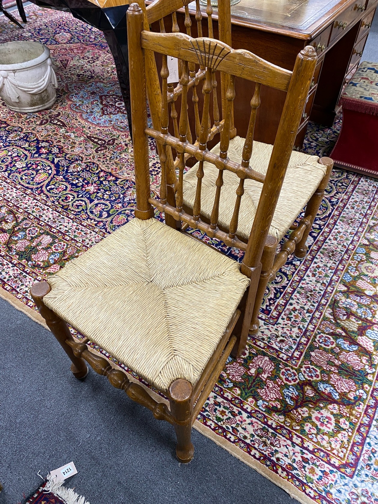A set of eight Lancashire style oak spindle back rush seat dining chairs